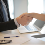 Two people shaking hands after receiving a job offer.