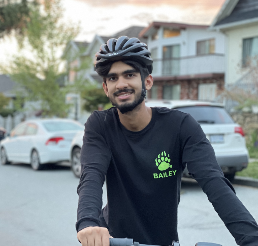 Sahil posing on bicycle.