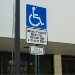 Van accessible parking spot sign with fines noted above it.