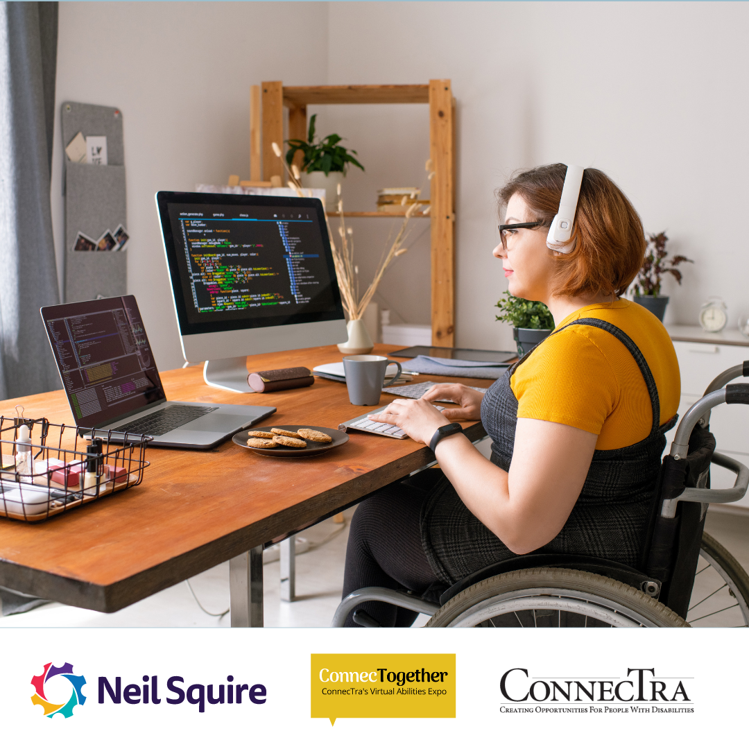 Woman in a wheelchair sits at a computer desk, typing on a keyboard.